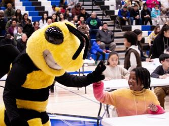 SCOE BEE gives a high five to speller