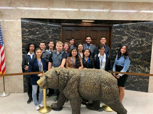 students in front of bear